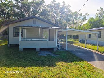 Charming single-story home featuring a cozy front porch and convenient carport at 851 Easy St, Brooksville, FL 34601