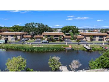 Waterfront condos featuring docks, manicured landscaping, and assigned parking at 10216 Seminole Island Dr, Largo, FL 33773