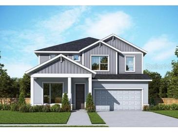 Two-story home featuring a modern design, well-manicured lawn, and integrated two-car garage at 11884 Richmond Trl, Parrish, FL 34219