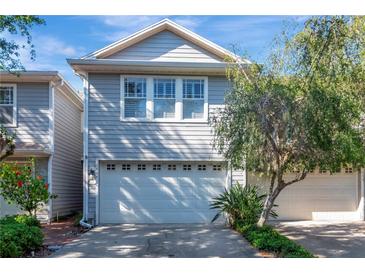 Charming two-story home featuring a two-car garage and beautifully landscaped front yard at 2837 Bayshore Trails Dr, Tampa, FL 33611