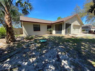 Charming single story house with a brick finish, a well-maintained lawn and a beautiful palm tree at 3257 Bluestone Ave, Spring Hill, FL 34609