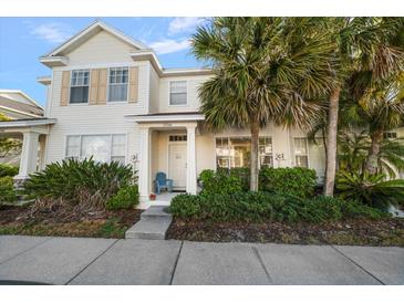 Charming two-story townhouse with lush landscaping, a quaint front porch, and neutral exteriors at 12346 Country White Cir, Tampa, FL 33635