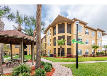 Beautiful exterior of the condo building with well-manicured landscaping and a gazebo at 4323 Bayside Village Dr # 229, Tampa, FL 33615