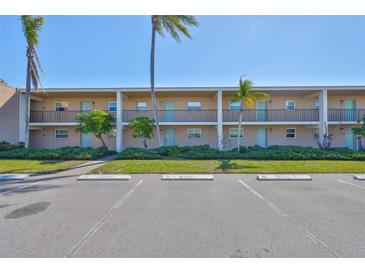 Multi-Gathering building with reserved parking and manicured landscaping under a bright blue sky at 12300 Park Blvd # 202, Seminole, FL 33772
