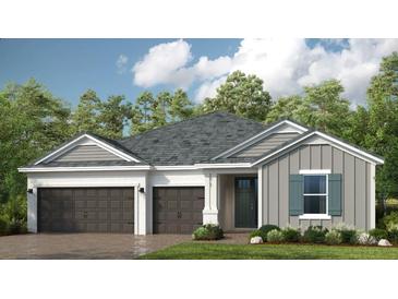 Charming single-story home featuring a three-car garage and neutral color palette with lush landscaping at 1711 Trailhead Ln, Zephyrhills, FL 33541