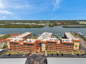 Panoramic aerial view of Bay Mariner condos, showcasing waterfront location and lush landscaping under a clear blue sky at 19701 Gulf Blvd # 210, Indian Shores, FL 33785