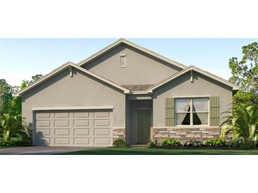 Charming single-story home featuring a two-car garage and stone accents at 3024 Living Coral St, Wimauma, FL 33598