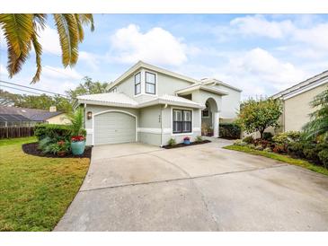 Charming home featuring a two-car garage, neutral paint, and a well-manicured lawn at 400 Westborough Ln, Safety Harbor, FL 34695