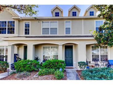 Charming townhome with a covered front porch, lush landscaping, and a welcoming entrance at 4676 66Th N Pl, Pinellas Park, FL 33781