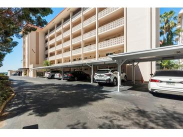 Condominium carport featuring assigned parking spots and shade from the sun at 620 Edgewater Dr # 501, Dunedin, FL 34698
