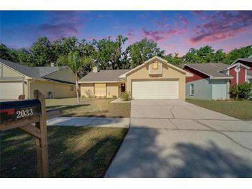 Charming one-story home with a well-manicured lawn and a two-car garage at 2033 Shadow Pine Dr, Brandon, FL 33511
