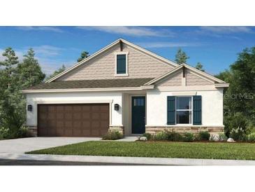 Charming single-story home with a well-manicured lawn, neutral palette, and a welcoming two-car garage at 1797 Trailhead Ln, Zephyrhills, FL 33541