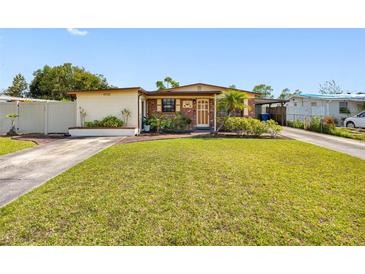 Charming single-story home with lush green lawn and well-maintained landscaping at 4532 W Idlewild Ave, Tampa, FL 33614