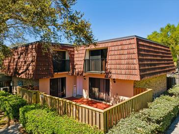 Charming two-story townhouse with a cozy fenced patio and upper level balconies at 2644 2Nd Ct, Palm Harbor, FL 34684