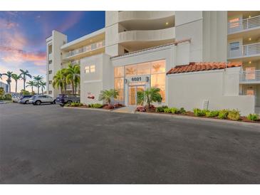 A view of the front of a building with palm trees in the parking lot and a sidewalk in front at 6021 Bahia Del Mar Cir # 137, St Petersburg, FL 33715
