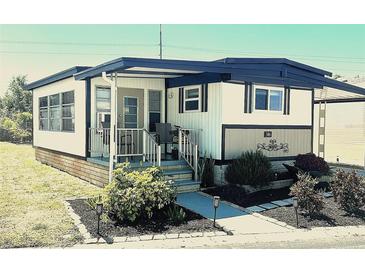 Charming single-story home with a covered front porch, landscaped yard and carport at 9790 66Th N St # 346, Pinellas Park, FL 33782