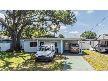 Charming single-story home featuring well-maintained landscaping and a spacious driveway at 2808 W Lake Ave, Tampa, FL 33607