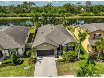 Inviting single-Gathering home featuring lush landscaping, neutral paint and a spacious driveway at 1612 Cabbage Key Dr, Ruskin, FL 33570