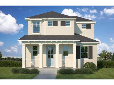 Charming two-story home featuring a welcoming front porch, neutral paint, and classic architectural details at 302 W Wilder Ave, Tampa, FL 33607