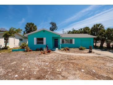 A single-story home with light blue exterior, complemented by palm trees in the yard at 340 83Rd Ave, St Pete Beach, FL 33706