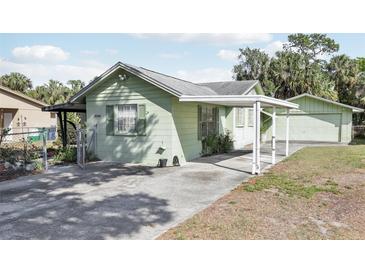 Charming single-story home featuring a covered carport and well-maintained landscaping at 6544 S West Shore Cir, Tampa, FL 33616