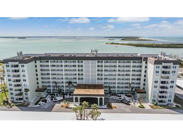 Exterior view of the building showing the entrance and the beautiful waterfront landscape at 9 Forbes Pl # 504, Dunedin, FL 34698