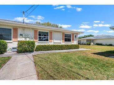 Charming single-story home with manicured lawn and inviting curb appeal at 1901 Canterbury Ln # 14, Sun City Center, FL 33573