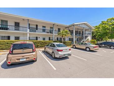 Inviting condo building with well-maintained landscaping and convenient parking for residents and guests at 100 Glennes Ln # 207, Dunedin, FL 34698
