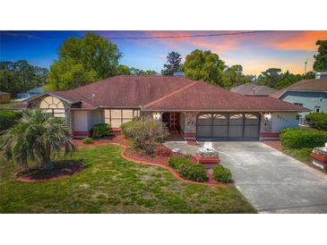 Charming single-story home with stone accents and well-manicured landscaping at 2017 Godfrey Ave, Spring Hill, FL 34609