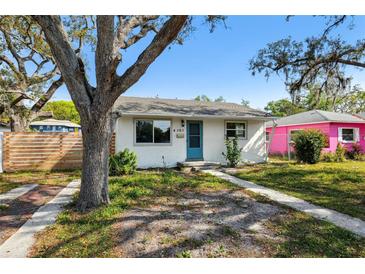Charming single story home with blue door, white paint and well manicured yard at 4701 14Th S Ave, St Petersburg, FL 33711