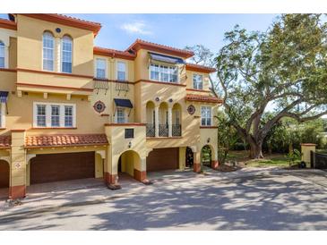 Mediterranean-style home featuring arched entryways and beautiful architecture with an attached garage at 264 Seagate Ct, Dunedin, FL 34698