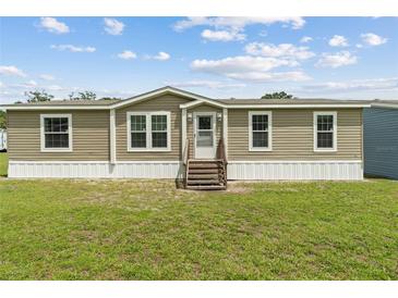 Charming single-story home with neutral siding, white trim, and a well-maintained front lawn at 11309 Tulane St, New Port Richey, FL 34654