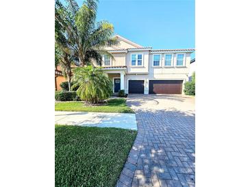 Charming two-story home with a well manicured lawn and a large driveway leading to a two car garage at 11936 Sand Myrtle Rd, Riverview, FL 33579