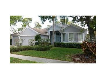 Charming single-story home with well-manicured lawn and lush landscaping, creating great curb appeal at 1803 Longview Ln, Tarpon Springs, FL 34689
