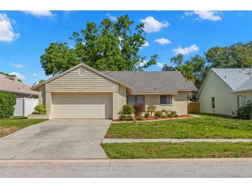 Charming single-story home with a well-maintained lawn and attached garage, offering curb appeal at 3261 Pine Forest Dr, Palm Harbor, FL 34684