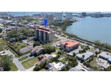 An aerial view shows the building is next to a pool and a tennis court at 7037 Sunset S Dr # 205, South Pasadena, FL 33707