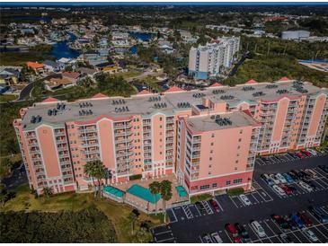 Aerial view of condo showcasing its pool, balconies, and proximity to waterfront living at 4516 Seagull Dr # 615, New Port Richey, FL 34652
