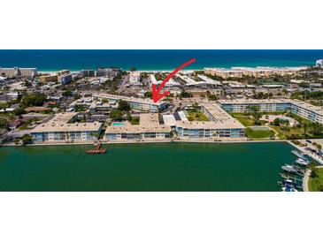 An aerial view of the condos, pier, and beach with water views in a lovely area at 6161 Gulf Winds Dr # 338, St Pete Beach, FL 33706