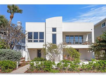 Contemporary two-story home featuring a modern architectural design and well-maintained landscaping at 2003 Gulf Way, St Pete Beach, FL 33706