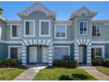 Charming townhome exterior with a well-maintained lawn and beautiful architectural details at 1304 Kelridge Pl, Brandon, FL 33511