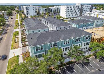 Aerial view of townhomes with gray roofs and parking in a walkable community near retail and restaurants at 3113 4Th N Ter, St Petersburg, FL 33713
