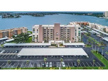 An aerial view of the property with assigned covered parking and a beautiful waterfront view at 7700 Sun Island S Dr # 404, South Pasadena, FL 33707