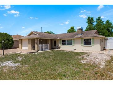Charming single-story home featuring a brick facade and an attached garage, inviting curb appeal at 6831 Greenwich Ave, New Port Richey, FL 34653