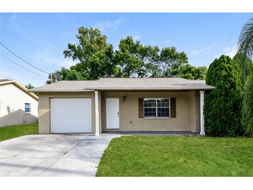 Charming single-story home with a well-maintained lawn and a one car garage at 7338 Coventry Dr, Port Richey, FL 34668
