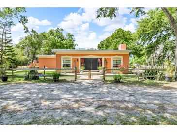 Charming single story home with a fenced yard, mature trees and colorful landscaping at 18826 Huckavalle Rd, Odessa, FL 33556