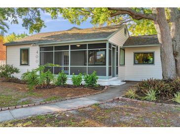 Charming single-story home with a screened-in porch and beautifully landscaped front yard at 400 38Th Ne Ave, St Petersburg, FL 33703