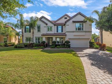 Beautiful two-story home with a well-manicured lawn and mature landscaping and a tile roof at 1804 Bella Casa Ct, Tampa, FL 33618