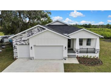 Charming single-Gathering home featuring a two-car garage and lovely landscaping at 38151 Sunset Ave, Dade City, FL 33525