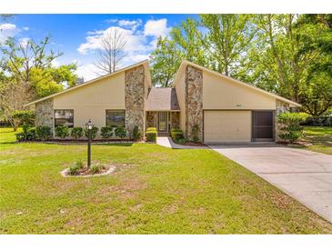 Charming single-story home boasts stone accents, a well-manicured lawn, and a convenient two-car garage at 24076 Ragan Dr, Brooksville, FL 34601