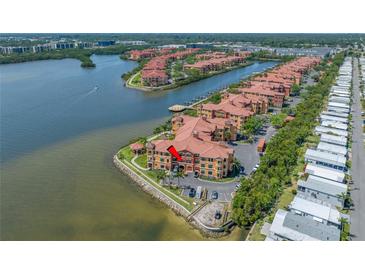 Stunning waterfront condominium complex featuring lush landscaping and serene water views at 2773 Via Cipriani # 1322A, Clearwater, FL 33764